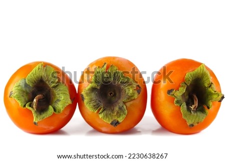 Three fresh ripe persimmon fruits isolated on white background