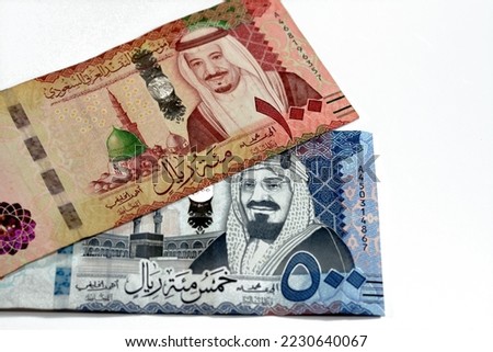 500 SAR Five hundred Saudi Arabia riyals cash money with king AbdulAziz Al Saud and Kabaa and 100 SAR one hundred Saudi Arabia riyals banknote with king Salman and Prophet mosque in Medina isolated Royalty-Free Stock Photo #2230640067