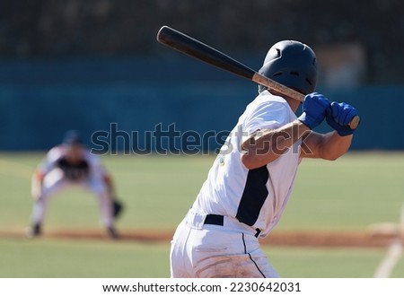 Baseball players in action on the stadium, baseball batter waiting to strike the ball Royalty-Free Stock Photo #2230642031