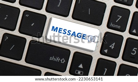 Message button written on a black keyboard. selective focus