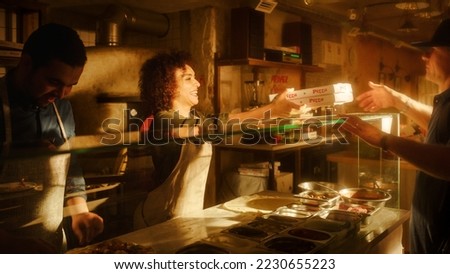 In Small Business Family Restaurant: Professional Couple of Chefs Preparing Pizza, Traditional Family Recipe, Giving Boxes to a Happy Customer. Authentic Sunny Pizzeria, Cooking Delicious Organic Food Royalty-Free Stock Photo #2230655223