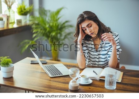 Thoughtful anxious business woman looking away thinking solving problem at work, worried serious young woman concerned make difficult decision lost in thought reflecting sit with laptop Royalty-Free Stock Photo #2230657503