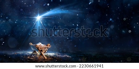 Nativity Scene - Birth Of Jesus Christ With Manger In Snowy Night And Starry Sky - Abstract Defocused Background Royalty-Free Stock Photo #2230661941