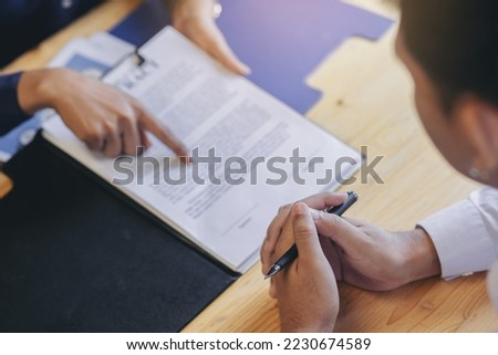 Business peoples reading documents at meeting, business partner considering contract terms before signing checking legal contract law conditions. Royalty-Free Stock Photo #2230674589