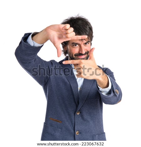 Man focusing with his fingers on a white background  