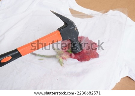 rose petals under pressure, eco print on a white t-shirt, beat off the flowers with a hammer and leave a mark on the t-shirt, rolling pin or hammer