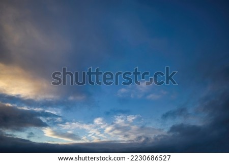 Exciting blue sky framed with clouds in golden hour