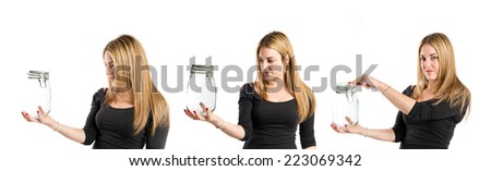 Young blonde girl listening music over white background 
