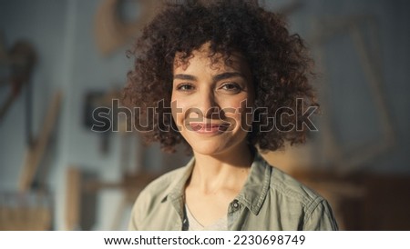 Close Up Portrait of a Beautiful Female Creative Specialist with Curly Hair Smiling. Young Successful Multiethnic Arab Woman Working in Art Studio. Dreaming About Better Life and Opportunities Ahead. Royalty-Free Stock Photo #2230698749