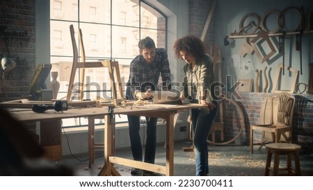 Portrait of Happy Young Business Couple Using Laptop Computer in Designer Furniture Studio. Carpenter and Designer Have Fun, DIscussing and Talking About Upcoming Orders of Wooden Furniture.