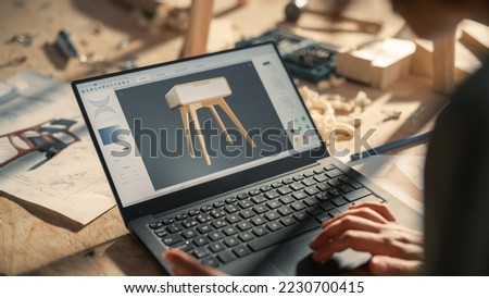 Close Up Shot of a Laptop Computer Screen with 3D Graphics Editor with Stylish Wooden Bedside Table Design. Creative Person Preparing a Furniture Item for Carpentry Project.