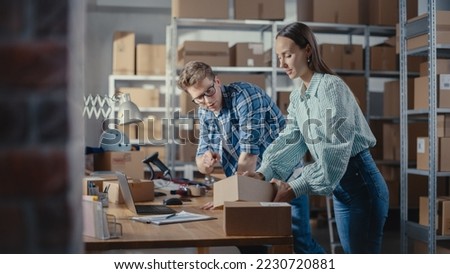 Young Male and Female Warehouse Inventory Managers Packing Orders for Clients, Using Laptop Computer and Checking Retail Stock. Employee Preparing a Parcel with Stylish Retro Bicycle Seat. Royalty-Free Stock Photo #2230720881