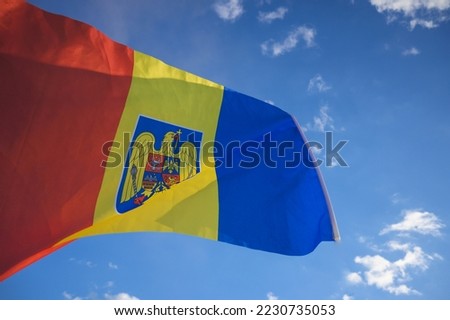 The Romanian flag fluttered in the wind with the blue sky in the background. December, 01- National Day of Romania. Royalty-Free Stock Photo #2230735053