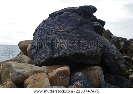 Sea wall with large rocks, piled up rocks