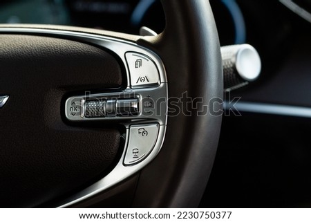 Cruise control switch closeup. Adaptive cruise control leaver. Cruise control on steering wheel. Royalty-Free Stock Photo #2230750377