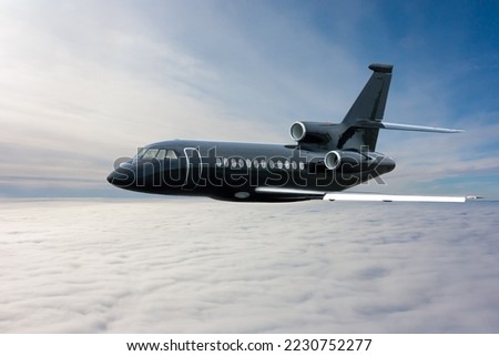 Black modern luxury executive aircraft flies in the air above the clouds Royalty-Free Stock Photo #2230752277
