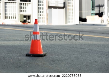View of an isolated construction signaling cone in the street. Maintenance and safety concept.	