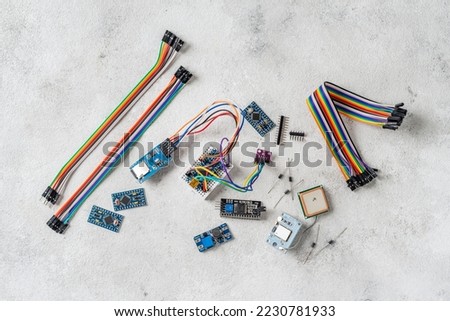 Boards, gps module and wires for arduino on a light background. Parts for self-assembly of various models and devices on the table top view Royalty-Free Stock Photo #2230781933
