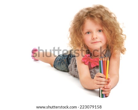 Happy little girl drawing with pencils at home