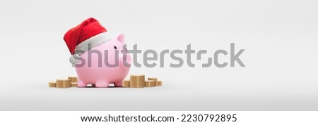 Pink piggy bank with santa claus hat on a white background - saving concept for christmas Royalty-Free Stock Photo #2230792895