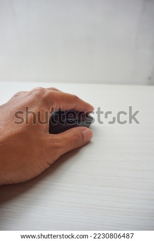 an asian hand is holding a mouse, on a white background