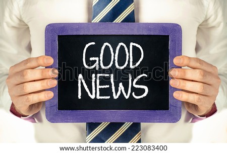 Chalkboard with with text good news. Man holding Chalkboard with with text good news 