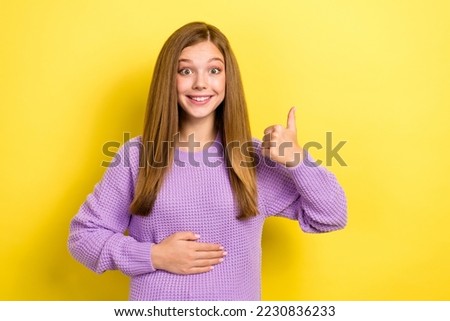 Photo of positive satisfied lady wear trendy knitted sweater hand touch belly thumb up good medicine isolated on yellow color background Royalty-Free Stock Photo #2230836233