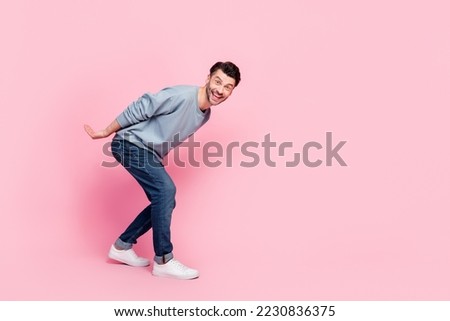 Full size photo of handsome young guy carry heavy invisible box empty space dressed trendy blue outfit isolated on pink color background Royalty-Free Stock Photo #2230836375