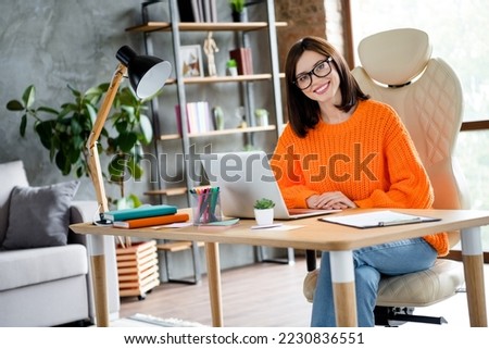 Photo of good mood positive lady wear orange sweater smiling creating start up modern device indoors workshop workplace