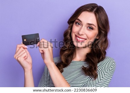 Close up photo of adorable cute lady two arm hold present plastic debit card recommend comfort using isolated on purple color background