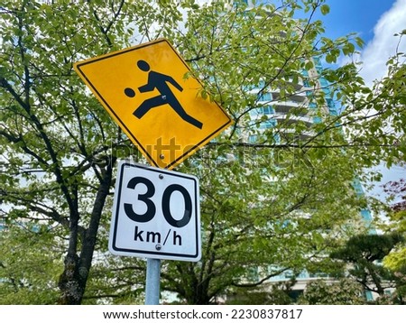 limit sign on the road kids playing 