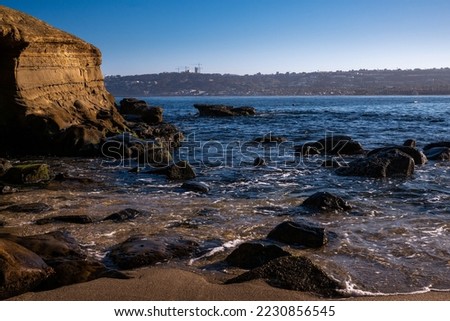 LA JOLLA COVES ROCKY SHORELING WITH LOW TIDE AND LA JOLA SHORES IN THE BACKGROUND