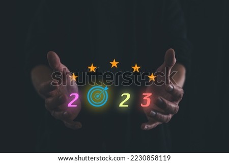 business target and goal on New year 2023 concept, hand holding 2023 virtual screen. new years business. new ideas coming up in the future.