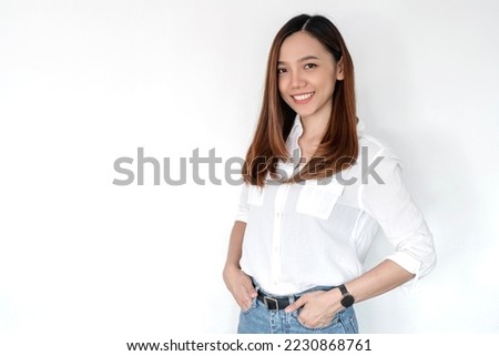 Image of happy young asian business woman posing isolated over white wall background.