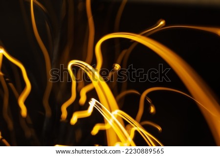 Black background with golden light effects. Horizontal background with blur bokeh effects for christmas time. Special occasion concept with space for text.