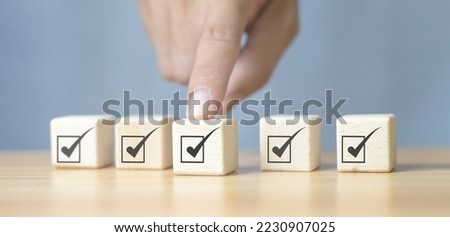Corporate Compliance Quality control management, ISO certification, product quality service guarantee. Assessment Enter a wooden cube with a check mark icon.