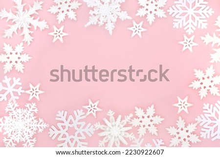 Festive Christmas magical ornate snowflake background on pastel pink. Fantasy design for winter, Xmas, New Year holiday season.