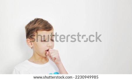 Cute little boy is coughing, onwhite background. Royalty-Free Stock Photo #2230949985