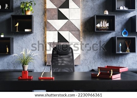 Manager's office setting. A black armchair next to a black desk. Horizontal photo Royalty-Free Stock Photo #2230966361