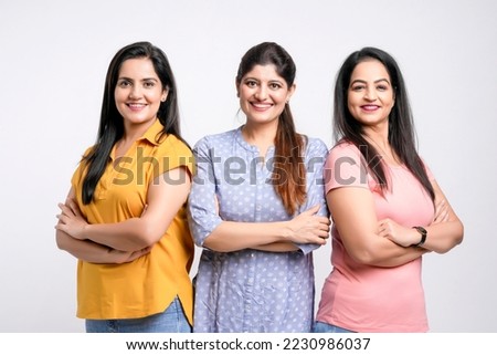 Three indian women giving expression together on white background. Royalty-Free Stock Photo #2230986037