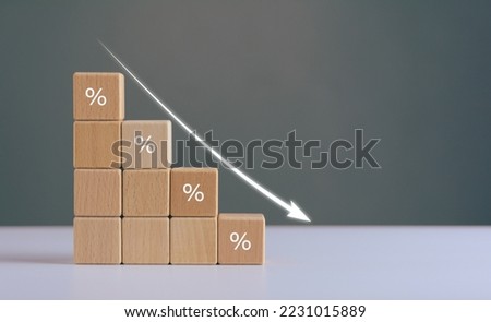 percentage of business turnover decreased, interest rate decline, Wood blocks with percentage sign and down arrow, recession crisis concept.