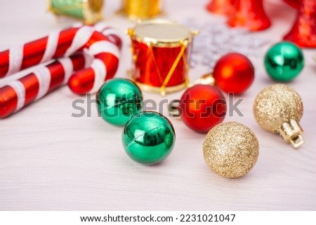 Christmas background with decorations. Gifts in craft paper, pine cones, red hearts and confetti.