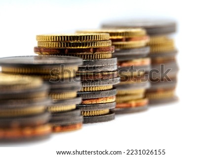 Close up of coins on white background with customizable space for text or ideas. Business and investment concept.