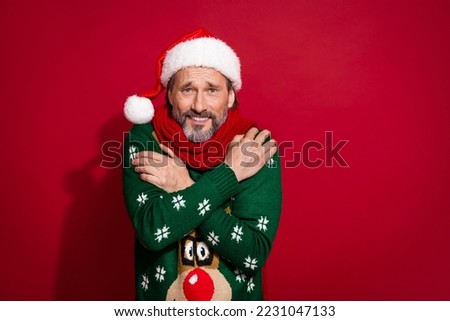 Photo of frozen cold person shivering arms embrace shoulder isolated on red color background