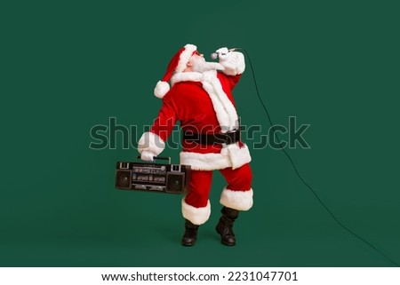 Full size photo of fat crazy grey white hair bearded santa claus sing x-mas christmas song hold boom box wear headwear cap isolated over bright shine color background