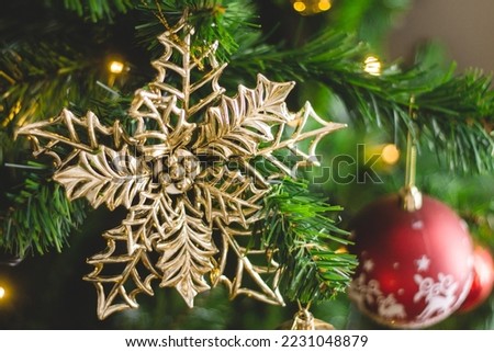 Gorgeous Christmas ornament star mistletoe garland in green, red and gold tree