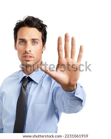 Stop right there. Studio shot of a young businessman showing a stop gesture.