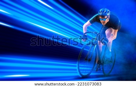 Man racing cyclist in motion on blue neon background. Sports banner. Horizontal copy space background
