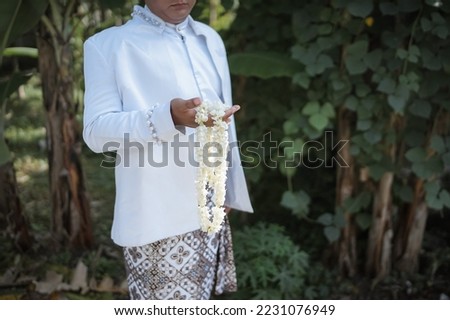 java man with traditinol married dress and flower