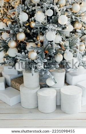 Pile of gift boxes near beautiful Christmas tree indoors